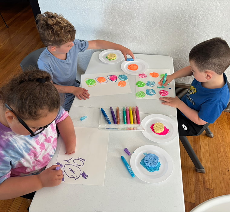 Children doing arts and crafts activities at a table