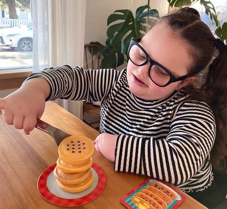 Child focused on educational activity at a table